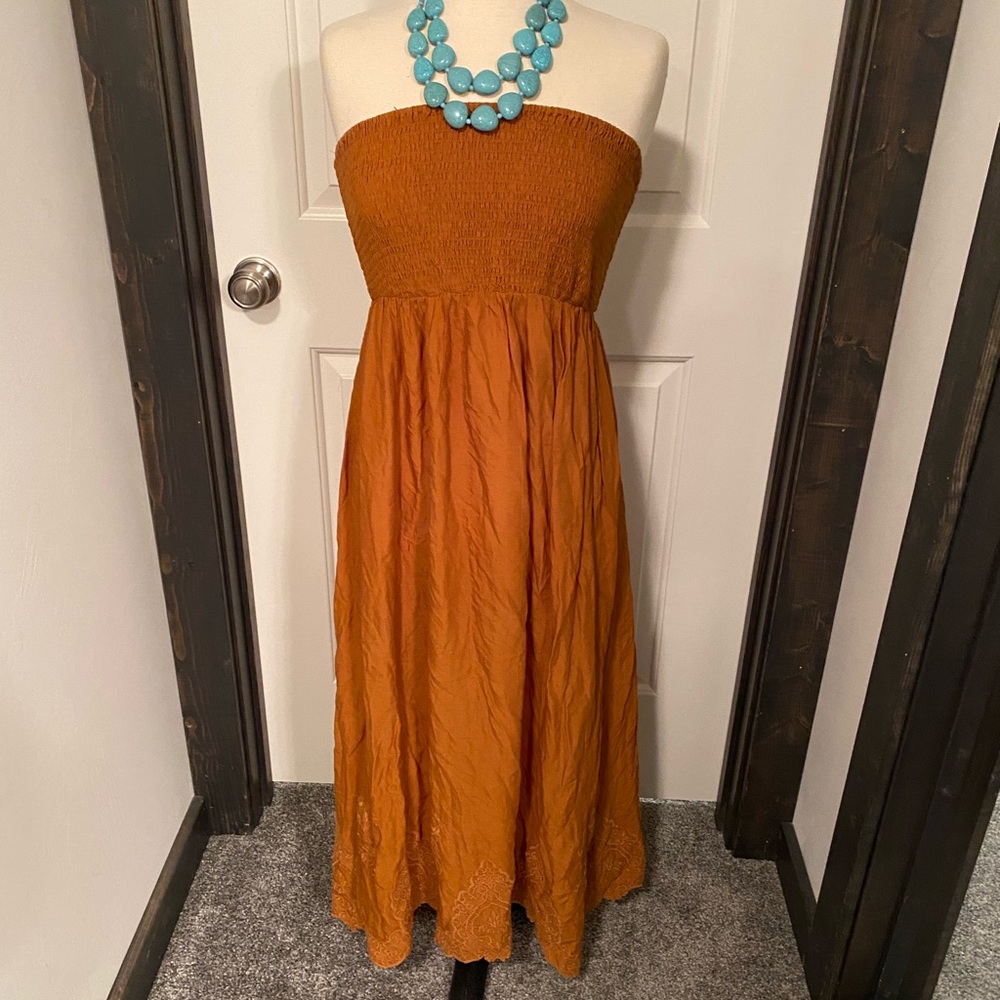 Cute staples dress with embroidered hem.